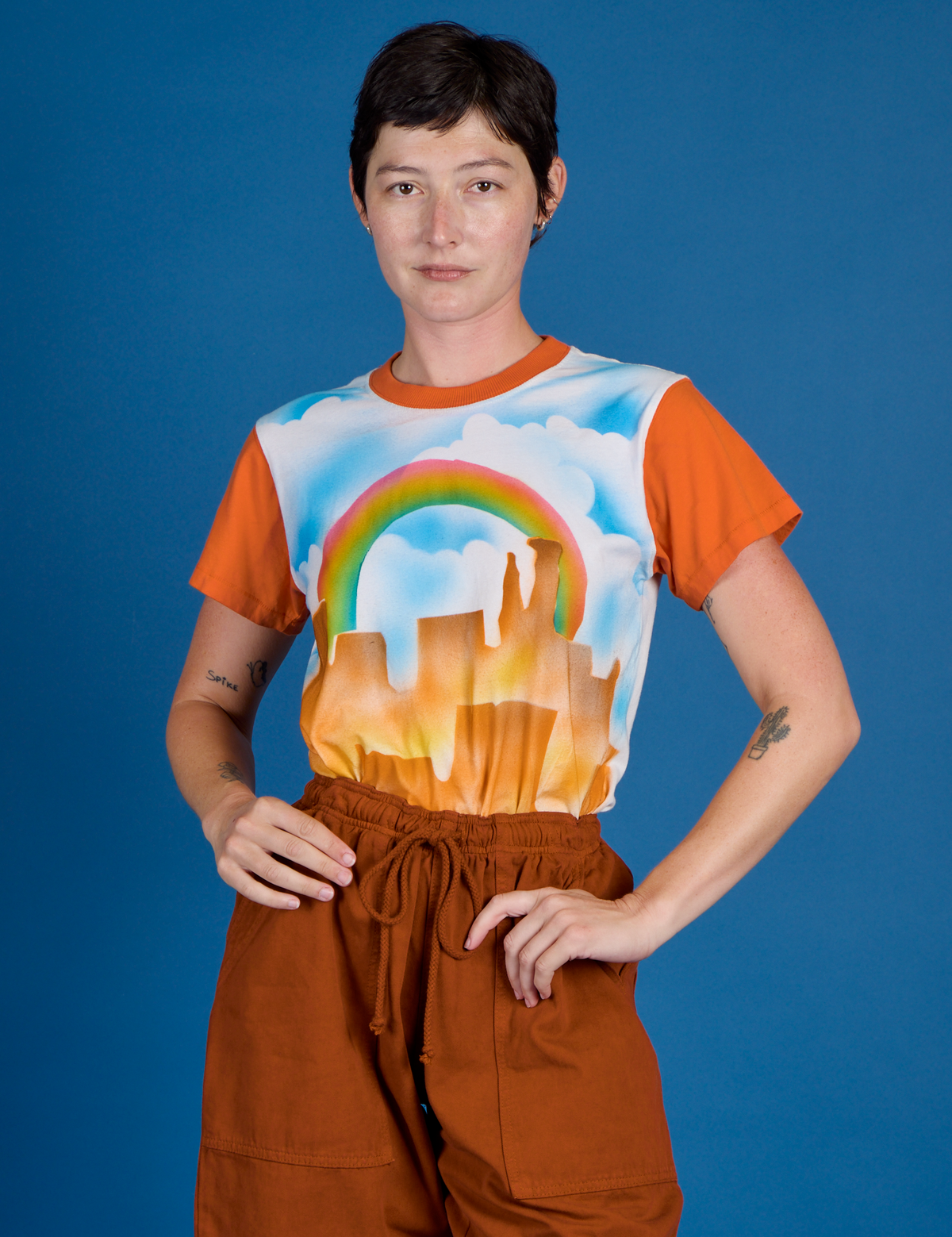 Alex wearing the Orange Mesa Airbrush Vintage Tee tucked in