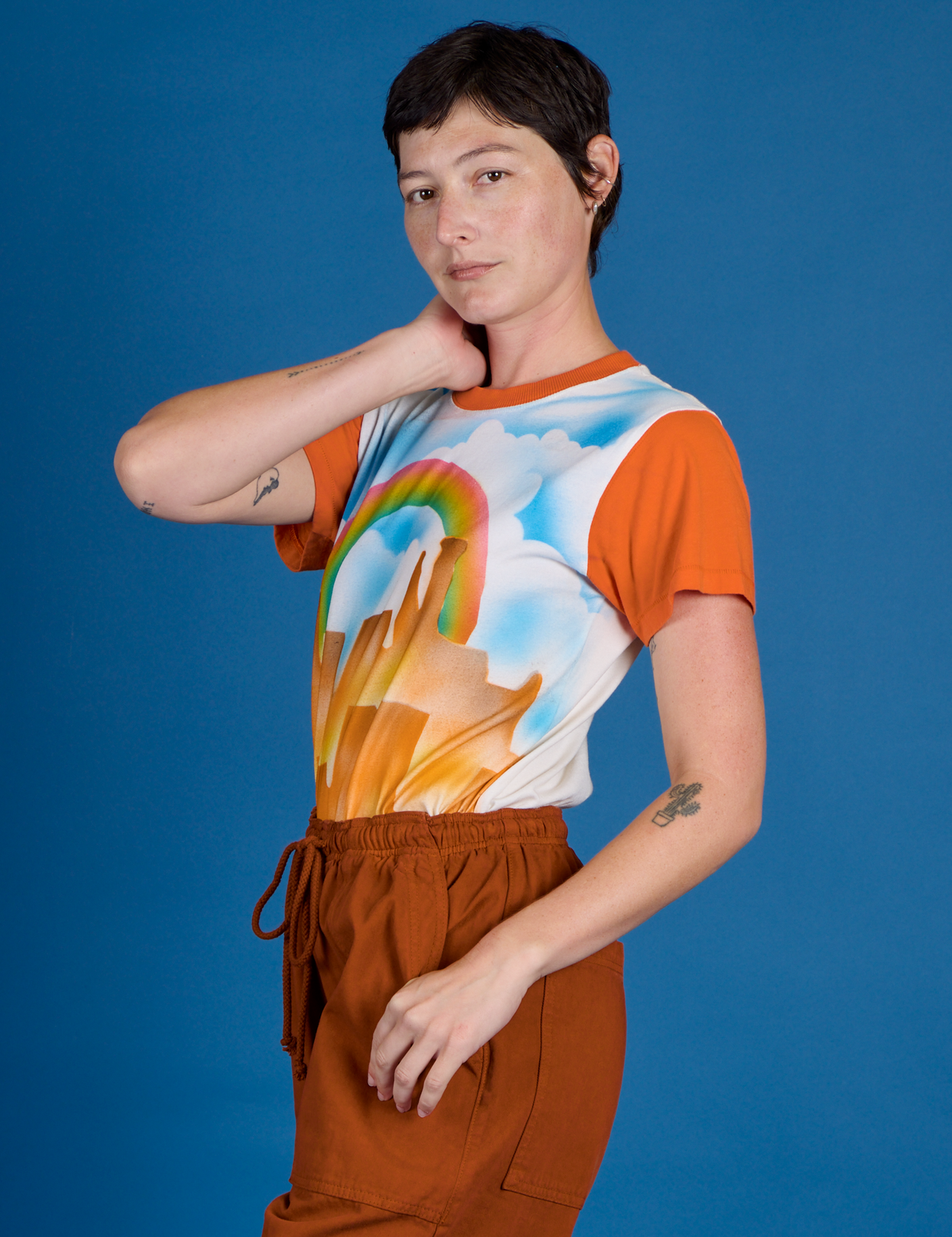 Side view of Alex in the Orange Mesa Airbrush Vintage Tee