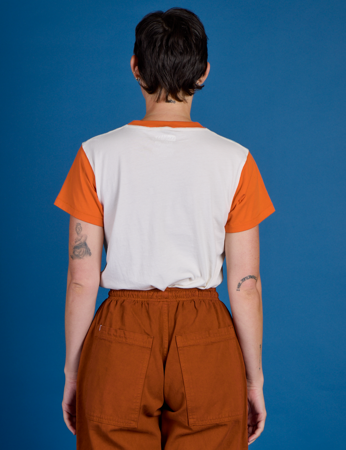 Back view of the Orange Mesa Vintage Airbrush Tee on Alex