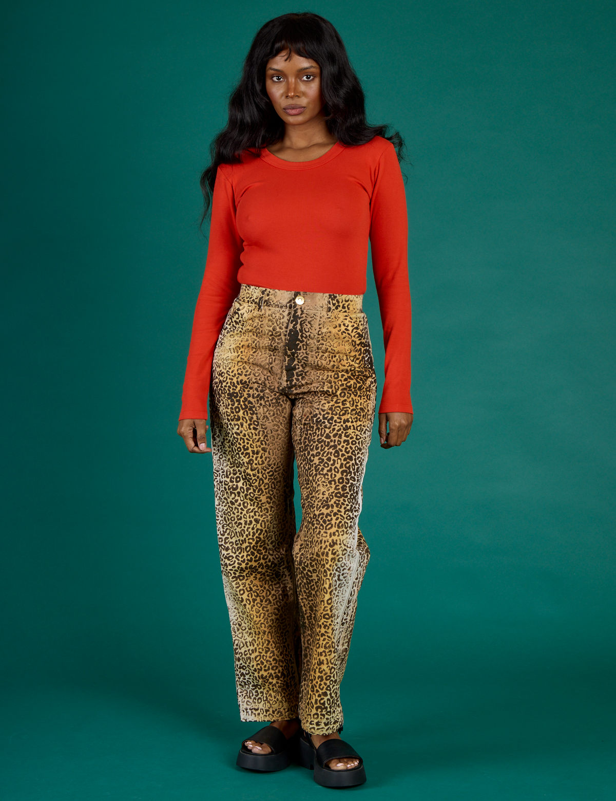Kandia is 5'3" wearing XS Leopard Work Pant with the Chili Red Long Sleeve Baby Tee