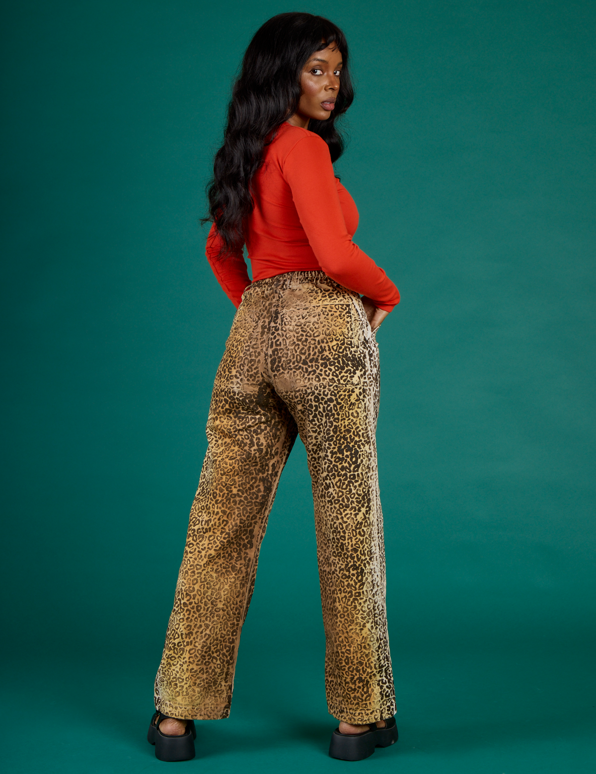 Angled back view of Kandia in the Leopard Work Pant