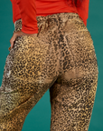 Close up of Kandia's hand in the back pocket of the Leopard Work Pant