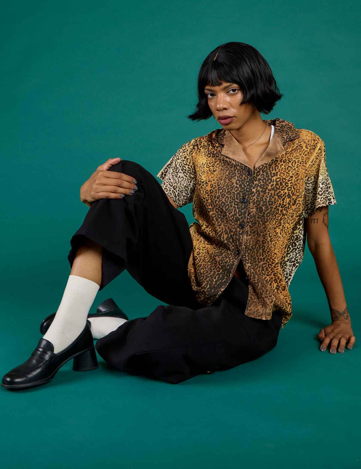 Kira wearing the Leopard Pantry Button Up with the Black Drop Pocket Pants
