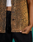 Close up on the buttons and hem of the Leopard Pantry Button Up worn by Kandia