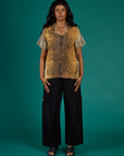 Kandia wearing the Leopard Pantry Button Up with the Black Drop Pocket Cargo Pant