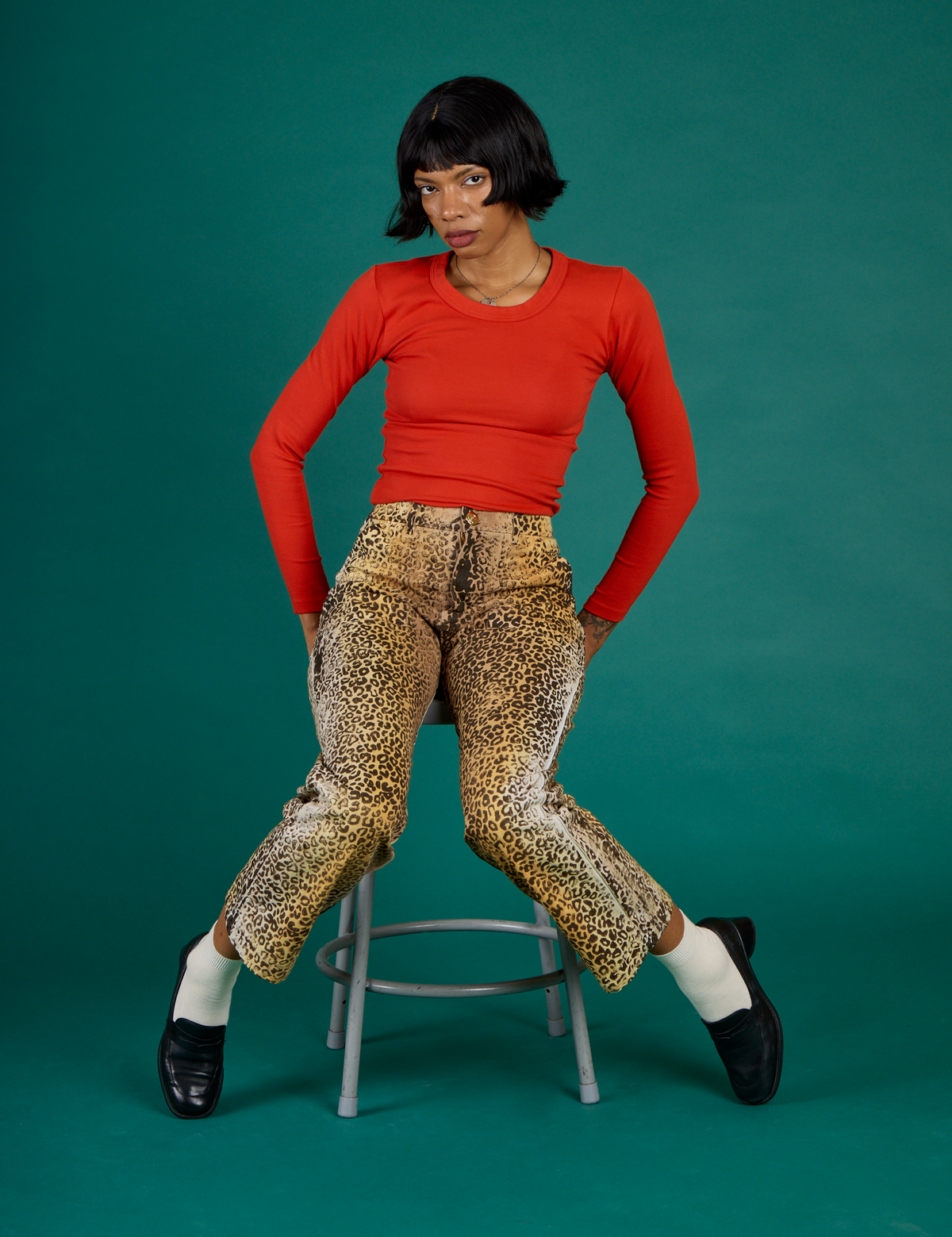 Kira wearing the Leopard Work Pant with the Chili Red Long Sleeve Baby Tee