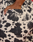 Close up of Kandia's hand in the back pocket of the Cow Work Pant