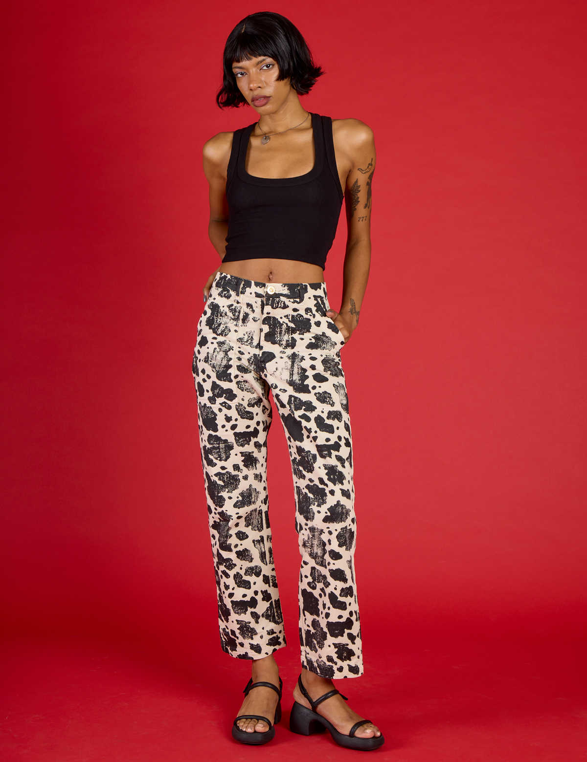 Kira is 5'10" wearing XS Cow Work Pant with the Black Cropped Tank