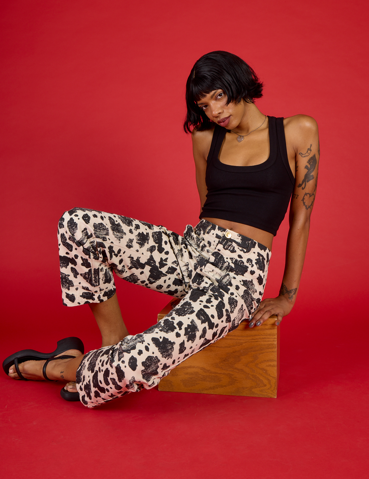 Kira wearing the Cow Work Pant with the Black Cropped Tank
