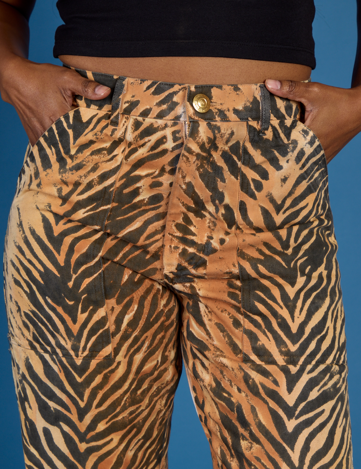 Close up of Kandia's hands in the front pockets of the Tiger Work Pant
