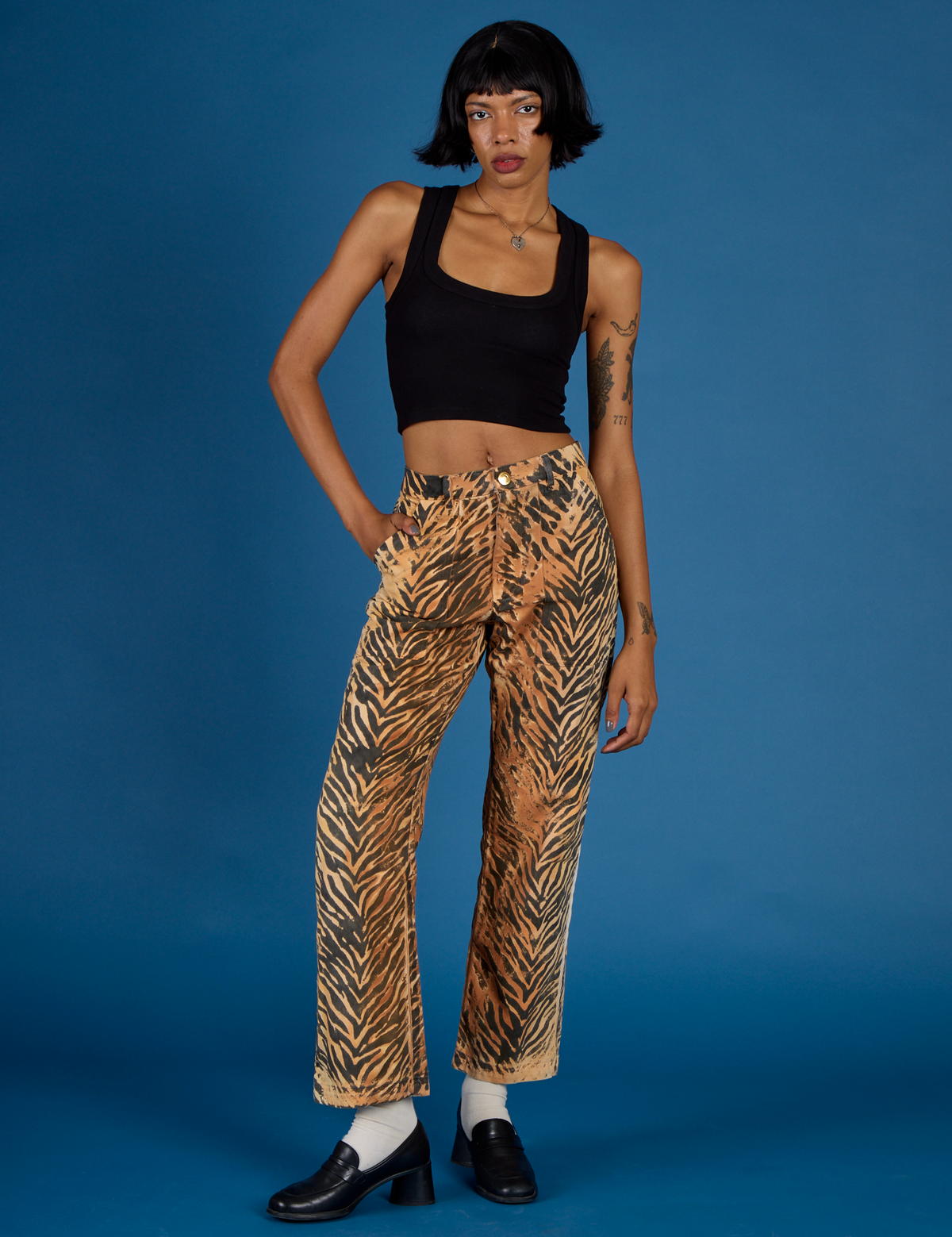 Kira is 5'10" and wearing XS Tiger Work Pant with the Black Cropped Tank