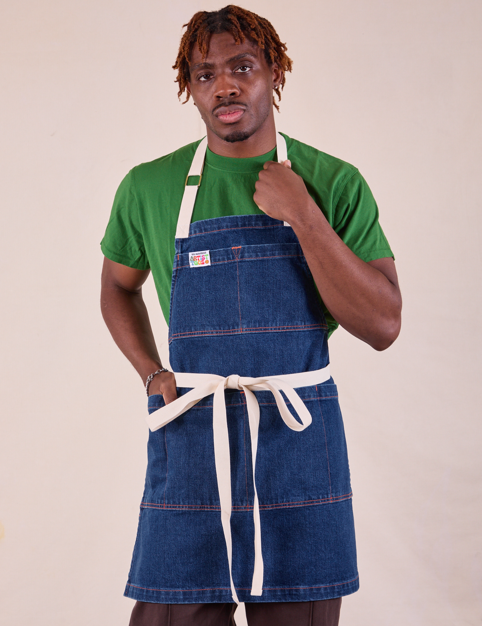 Isaac is wearing Full Indigo Denim Apron in dark wash