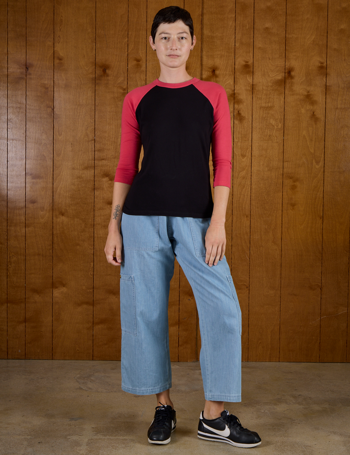 Alex is 5'8" and wearing P Black/Pink Colorblock Raglan Tee with Light wash Denim Drop Pocket Pants