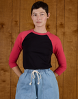 Alex wearing the Black/Pink Colorblock Raglan Tee tucked in