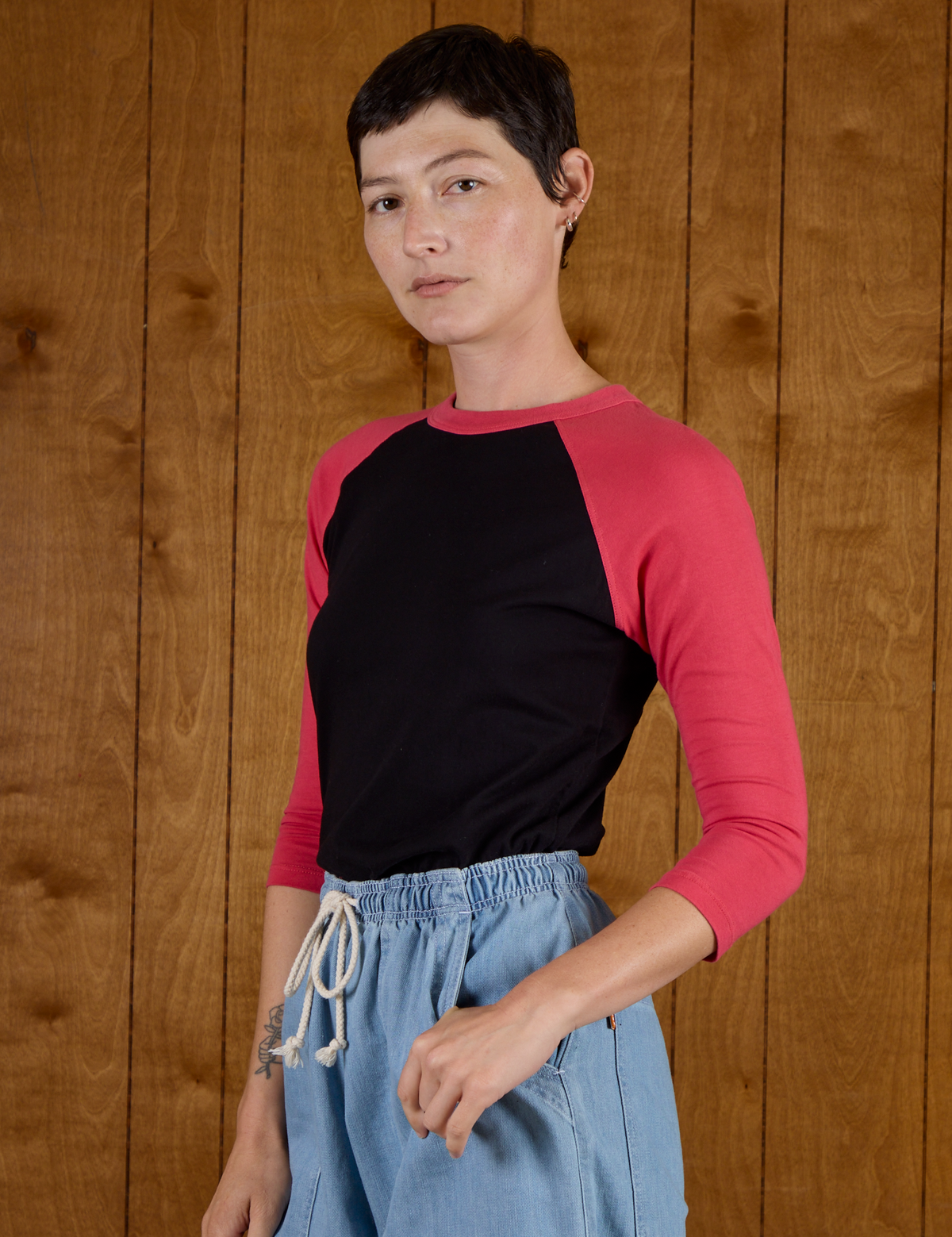 Angled side view of the Black/Pink Colorblock Raglan Tee
