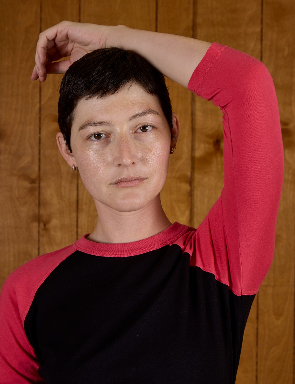 Close up of Alex in the Black/Pink Colorblock Raglan Tee