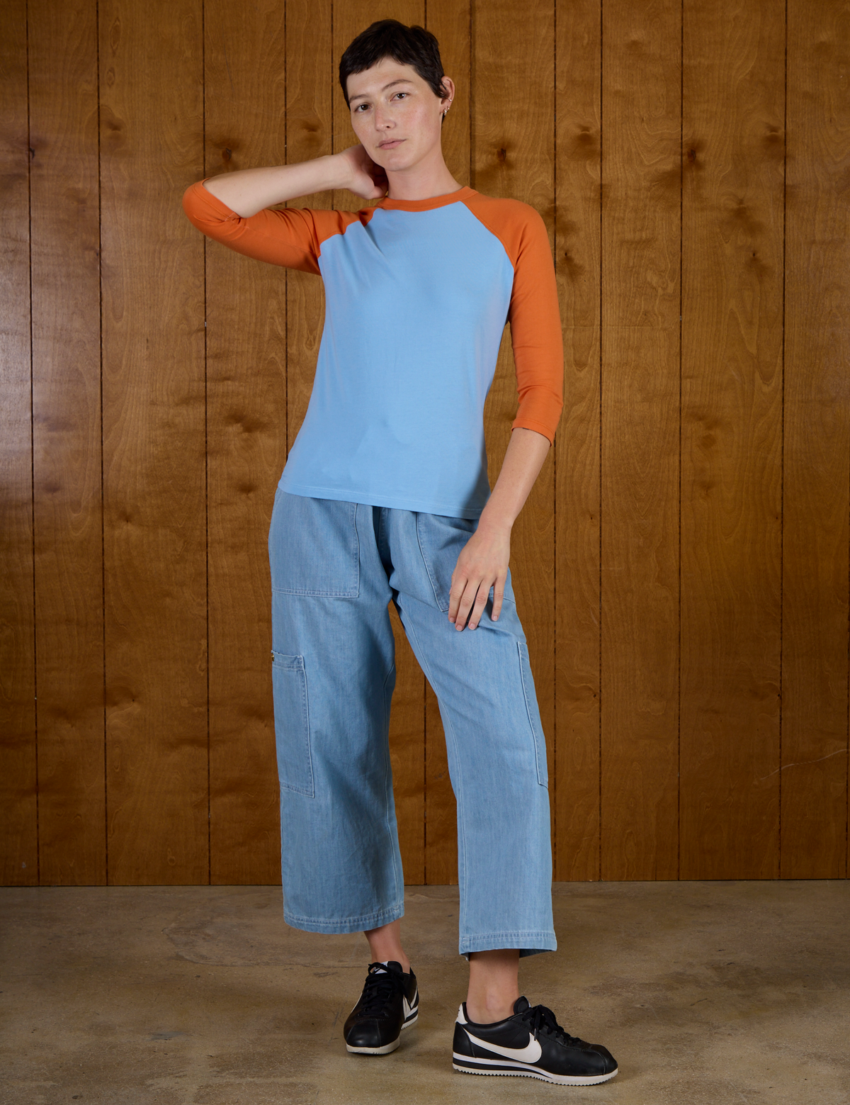 Alex wearing the the Baby Blue/Orange Colorblock Raglan Tee untucked with the Light Wash Denim Drop Pocket Pants