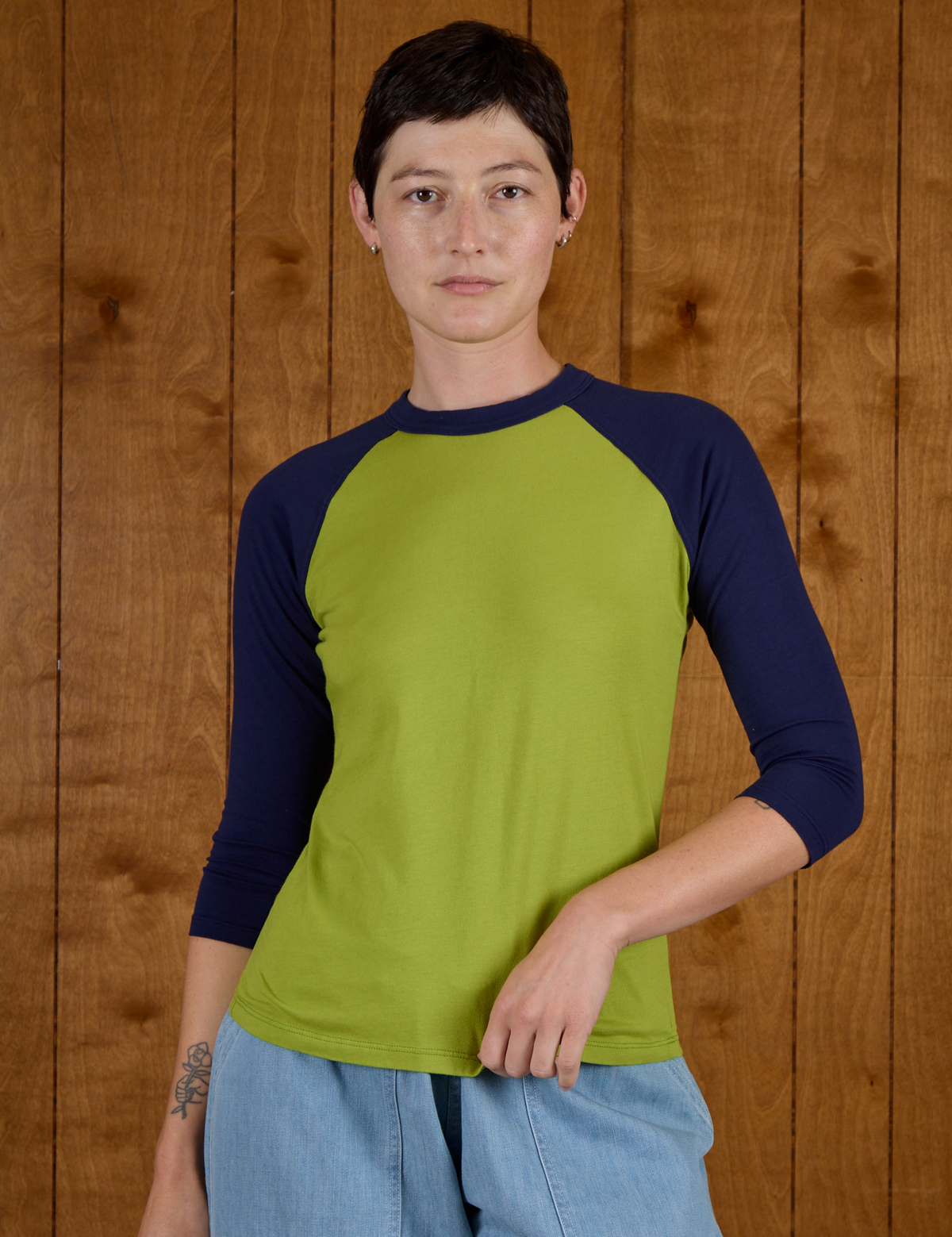 Alex is 5'8" and wearing P Gross Green/Navy Colorblock Raglan Tee
