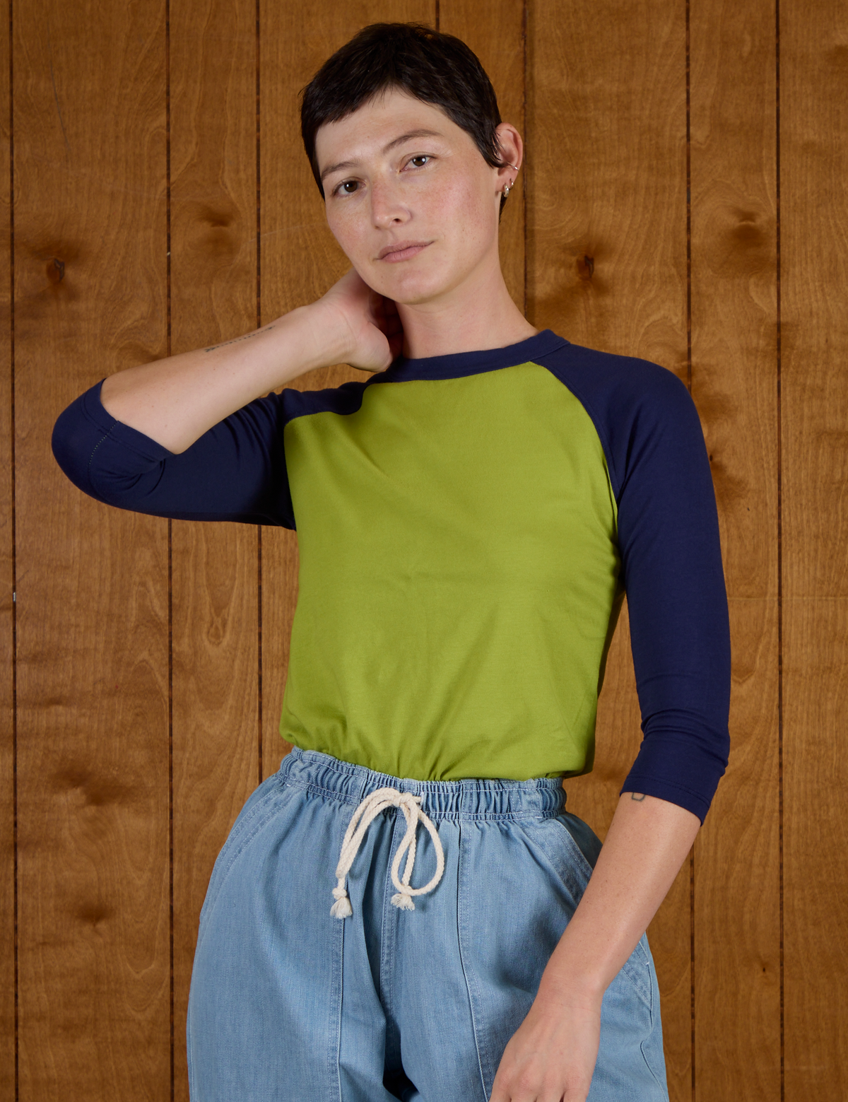 Alex wearing the Gross Green/Navy Colorblock Raglan Tee tucked into the Light Wash Denim Drop Pocket Pants