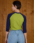 Back view of Alex wearing the Gross Green/Navy Colorblock Raglan Tee