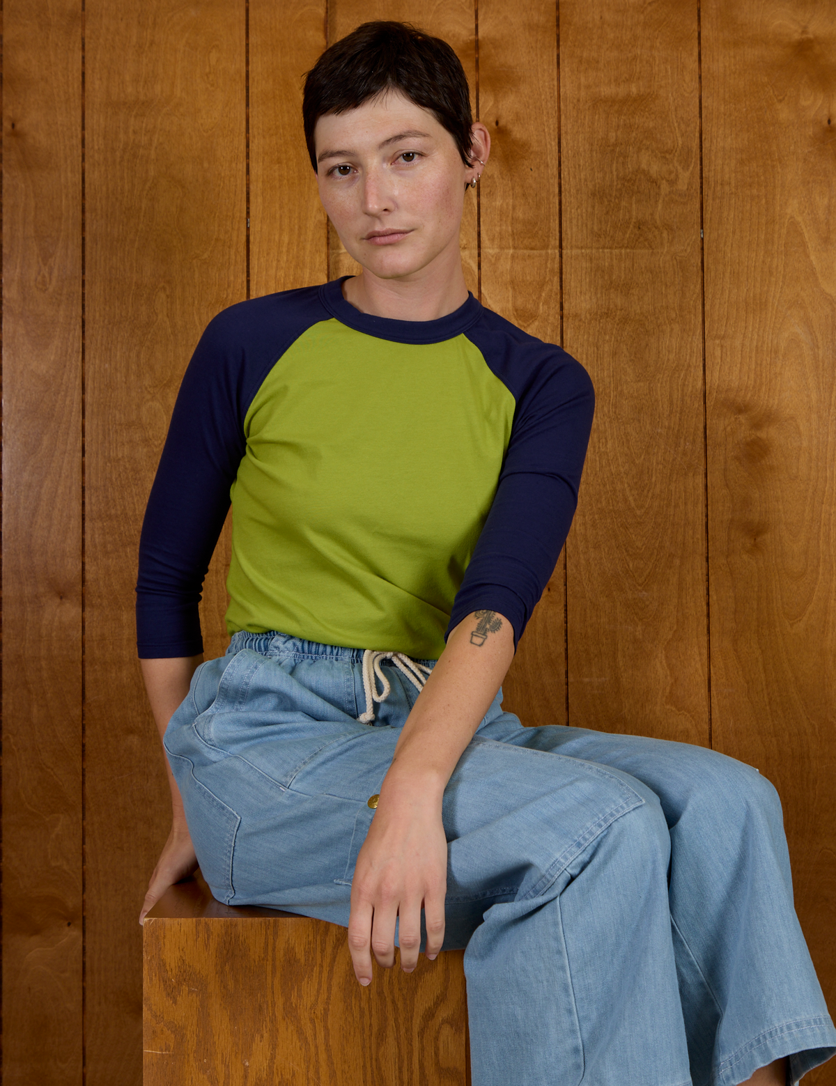 Alex wearing the Gross Green/Navy Colorblock Raglan Tee with the Light Wash Drop Pocket Pants