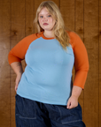 Juliet is 5'7" and wearing L Baby Blue/Orange Colorblock Raglan Tee