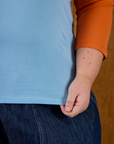 Close up of hem on the Baby Blue/Orange Colorblock Raglan Tee worn by Juliet