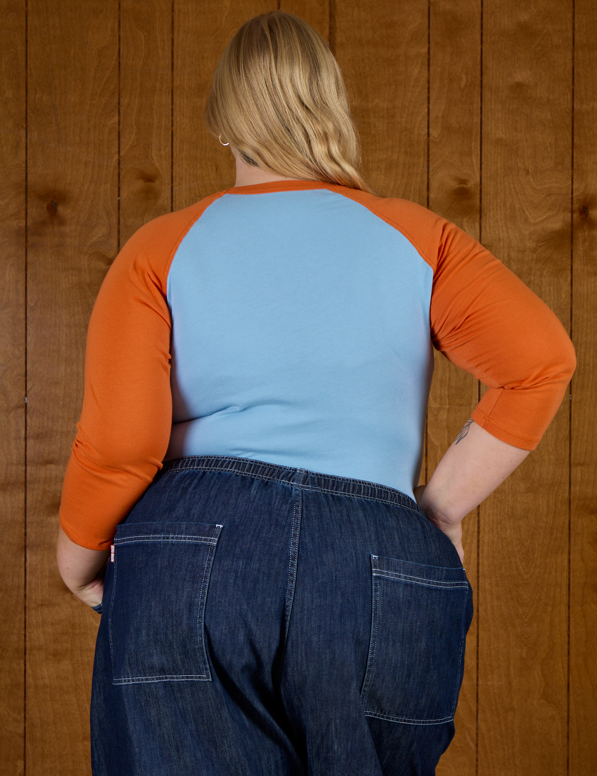 Back view of the Baby Blue/Orange Colorblock Raglan Tee on Juliet
