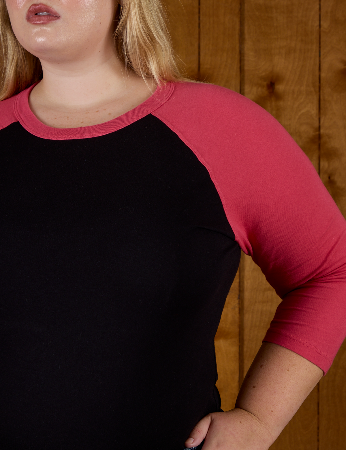 Close up of the the Black/Pink Colorblock Raglan Tee's sleeve on Juliet