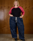 Juliet in the Black/Pink Colorblock Raglan Tee tucked into the Dark Wash Denim Drop Pocket Pants