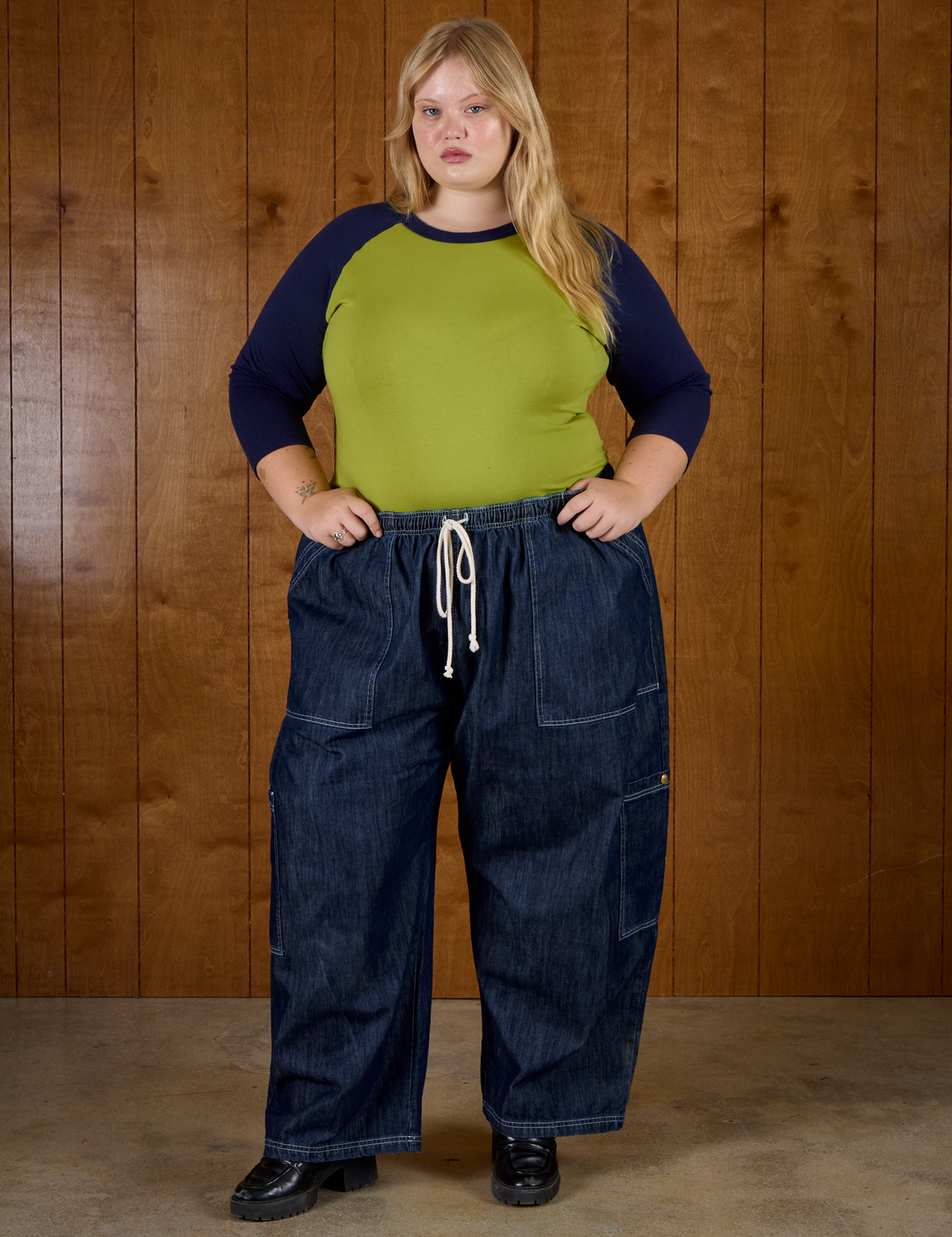 Juliet wearing the Gross Green/Navy Colorblock Raglan Tee tucked into the Dark Wash Denim Drop Pocket Pants