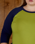 Close up  he Gross Green/Navy Colorblock Raglan Tee's sleeve worn by Juliet