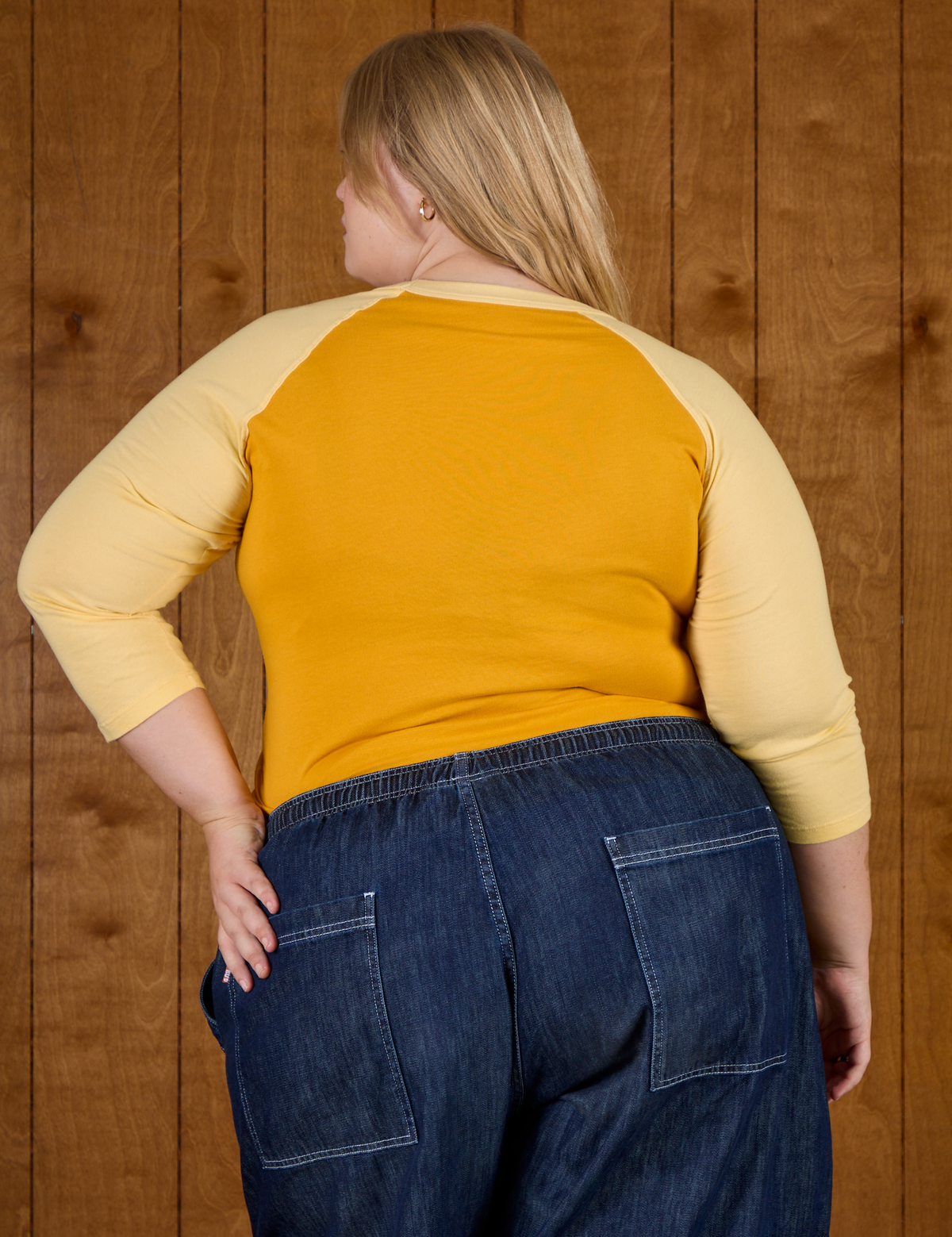 Back view of Juliet wearing the Mustard Yellow/Butter Raglan Tee