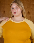 Close up of Juliet in the Mustard Yellow/Butter Raglan Tee