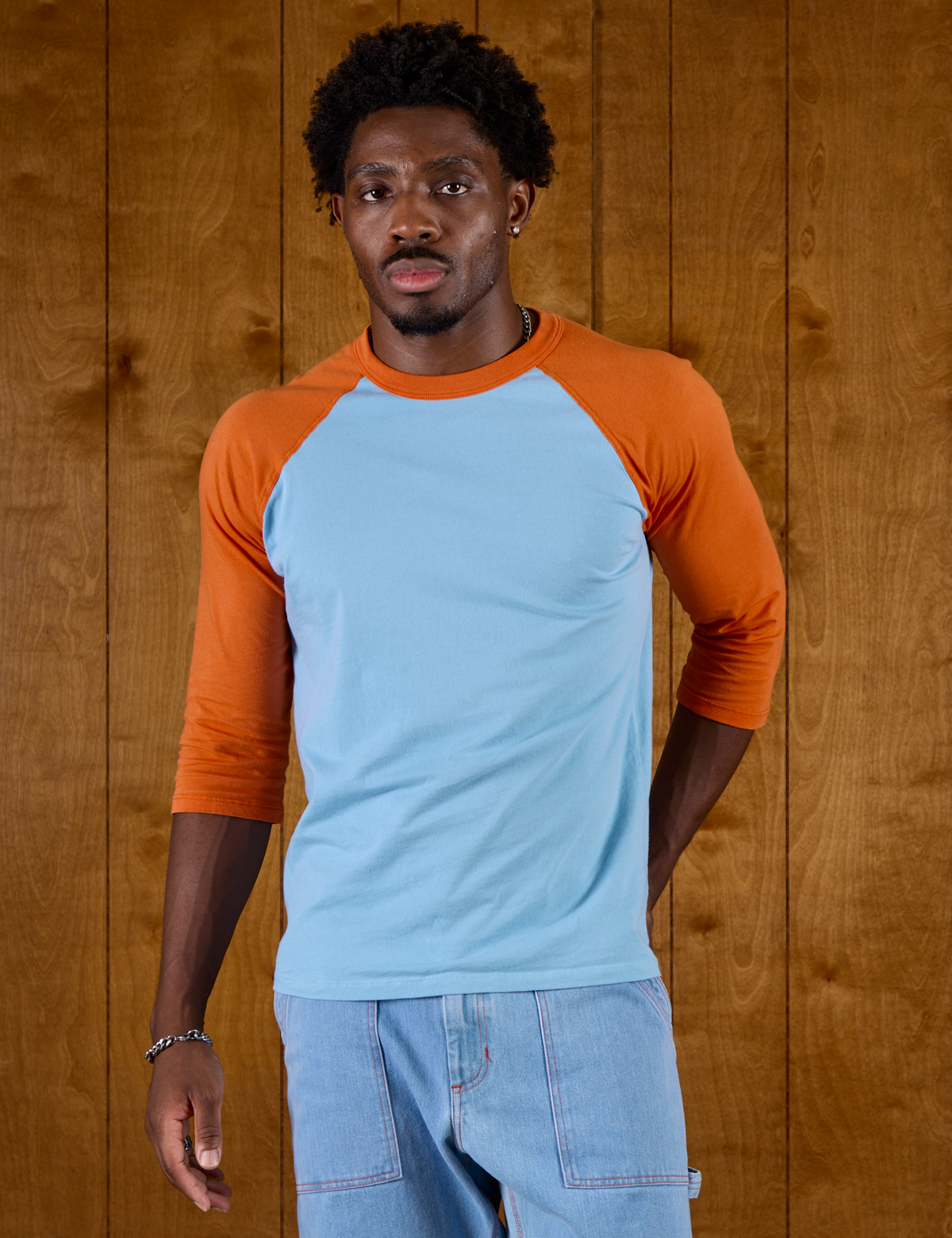 Isaac is 5'9" and wearing M Baby Blue/Orange Colorblock Raglan Tee