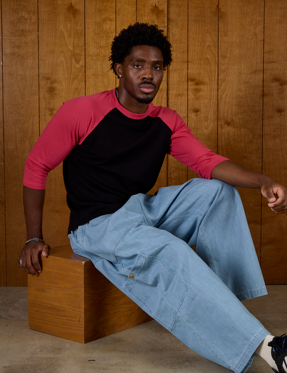 Isaac wearing the Black/Pink Colorblock Raglan Tee with Light Wash Denim Drop Pocket Pants