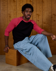 Isaac wearing the Black/Pink Colorblock Raglan Tee with Light Wash Denim Drop Pocket Pants