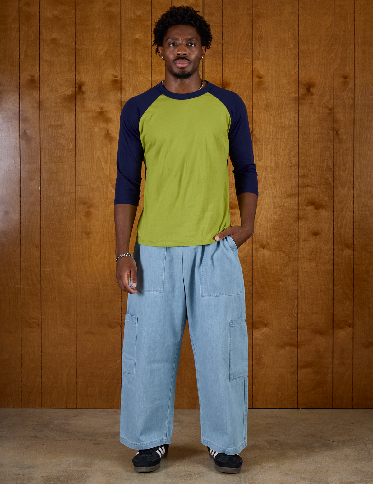 Isaac is 5'9" and wearing M Gross Green/Navy Colorblock Raglan Tee with Light Wash Denim Drop Pocket Pants