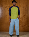Isaac is 5'9" and wearing M Gross Green/Navy Colorblock Raglan Tee with Light Wash Denim Drop Pocket Pants