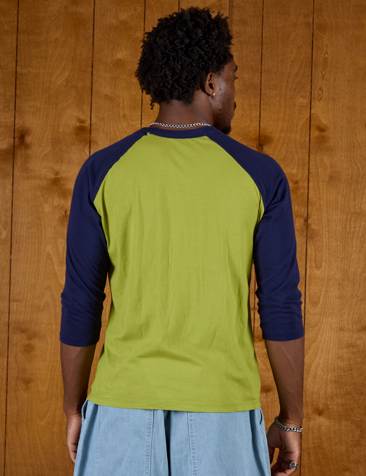 Back view of the Gross Green/Navy Colorblock Raglan Tee on Isaac