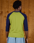 Back view of the Gross Green/Navy Colorblock Raglan Tee on Isaac