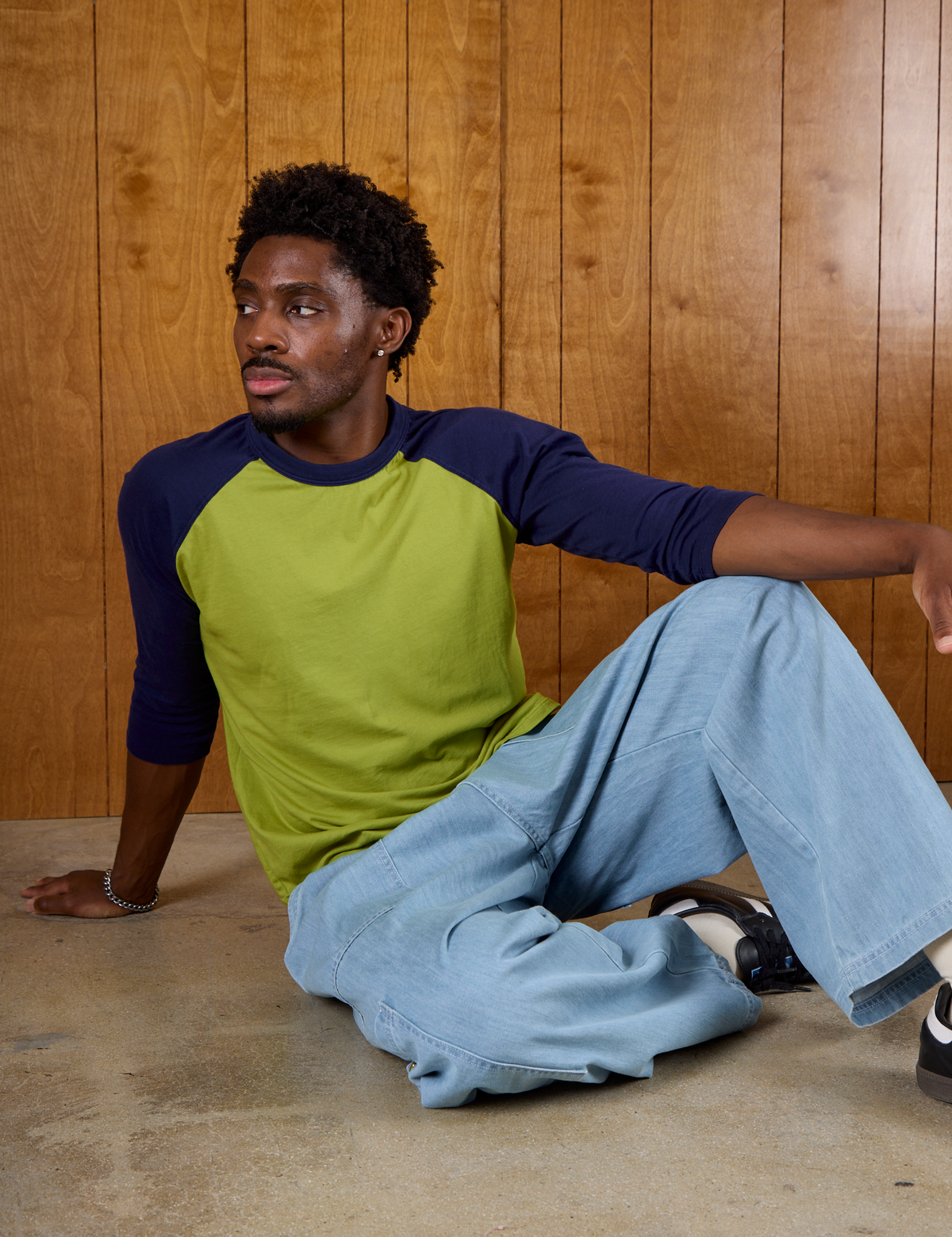 Isaac wearing  the Gross Green/Navy Colorblock Raglan Tee and Light Wash Denim Drop Pocket Pants