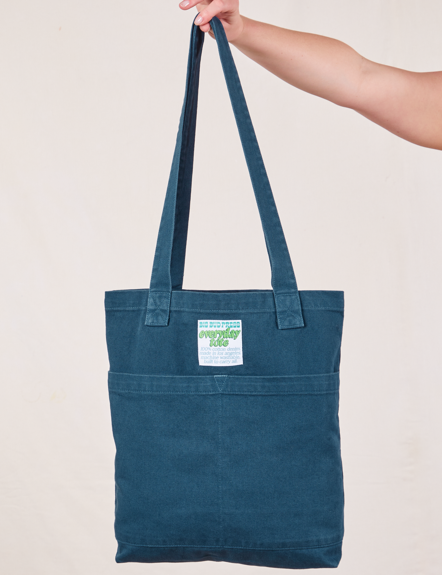 Everyday Tote Bag in Lagoon held by strap