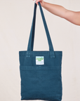 Everyday Tote Bag in Lagoon held by strap