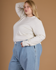 Angled side view of Juliet wearing the Vintage Tee White Long Sleeve Burly Tee