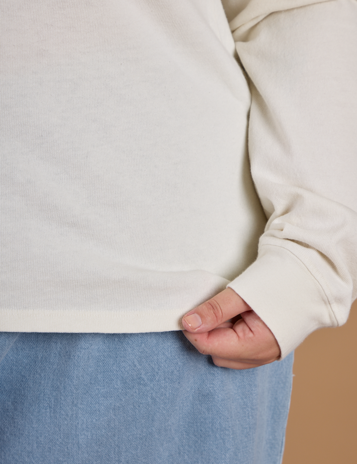 Close up of the hem on the Vintage Tee White Long Sleeve Burly Tee worn by Juliet