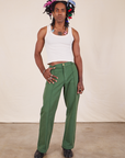 Jerrod is 6'3" and wearing M Long Western Pants in Dark Emerald Green paired with vintage off-white Cropped Tank Top