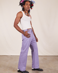 Side view of Western Pants in Faded Grape and vintage off-white Tank Top on Jerrod
