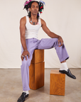 Jerrod is wearing Western Pants in Faded Grape and vintage off-white Tank Top