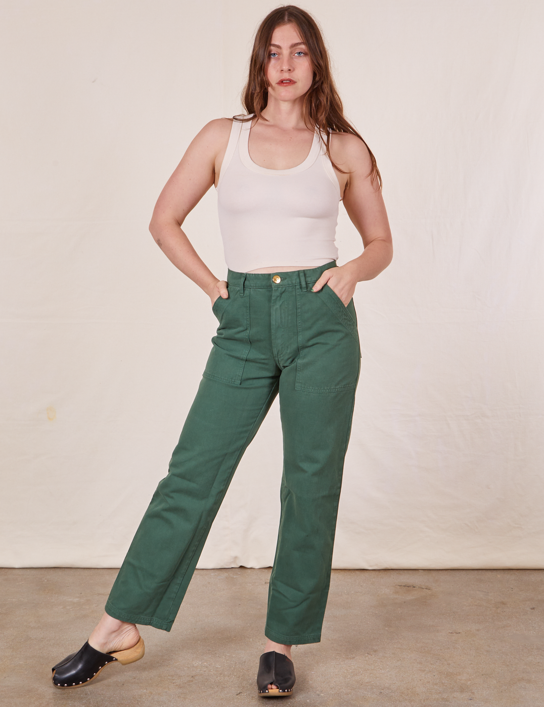 Allison is 5'10" and wearing Long S Work Pants in Dark Emerald Green paired with vintage off-white Tank Top